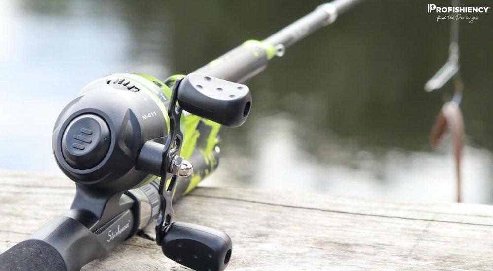 spincast rod and reel on a dock overseeing a lake 
